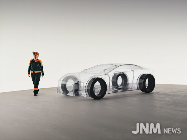 A dedicated Sandvik engineer walks around the eNimon, assessing the eNimon, which highlights the critical, often unseen, reliance on robust mining infrastructure to power the EV future.