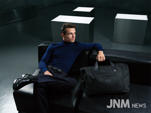 Lando Norris pictured with the Alpha Double Expansion Duffel in Black.